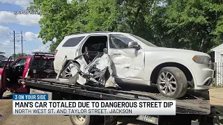 Jackson resident says dangerous road dip has caused 10 to 12 crashes into his property
