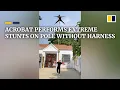 Download Lagu Acrobat performs extreme stunts on pole without harness