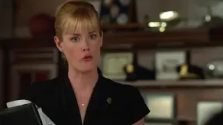 Abigail Hawk in nylons and a short sleeved black dress