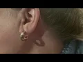 Red heart tattoo behind the ear