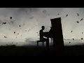 silhouette of a man playing the piano in the dark