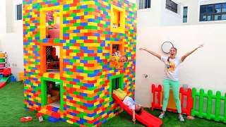 vlad and niki play with colored toy blocks and build three level house