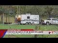 Crews search for body in Preble County lake