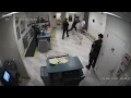 shows Washington County jail deputy attacking suspect during booking photo