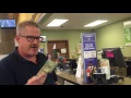 Manny from Alt 107 3 buying a Kansas Lottery ticket for the Holiday Millionaire Raffle