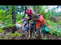 Lagu agricultural vehicle transporting used motorbikes across dangerous stream