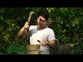 Making watermelon juice using a giant wooden press—to sell at the village market.