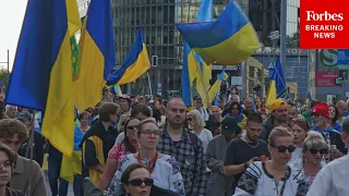 Germans Wave Flags To Demand End To Russia-Ukraine War And Celebrate Ukrainian Independence