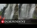 Water pours down rocks close to Bear Mountain Bridge after storm lashes New York