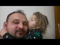 The little girl wants her father to kiss his ear