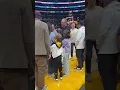 Ashton and Mila comfort their daughter at basketball game