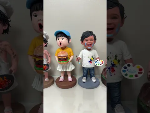 A handmade clay bobblehead wave from left to right.
