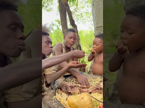 Hadzabe family enjoying spaghetti and baboon meat
