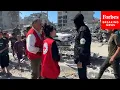 Members Of Hamas' Al-Qassam Brigades Speak To Red Cross Teams During Hostage Recovery Efforts