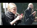 Anya Taylor-Joy perches on the pavement to smoke a cigarette