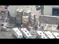 Water no longer being sprayed crews seen climbing OC chemical tank
