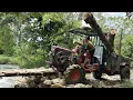 Download Lagu agricultural vehicle transporting timber across deep stream