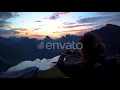 Young Woman Make Photo of Sunset Background Mountains | Stock Footage - Videohive