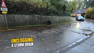 #081-1 Unclogging a storm drain on a road after rain in Germany