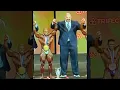 Strongman standing next to bodybuilders