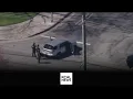 Police and SWAT teams surround a suspect on a Northridge street who is wanted for a weapons charge