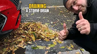 #079-2 Unclogging a storm drain on a parking space during rain in Germany