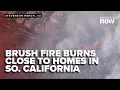 Southern California brush fire burns dangerously close to homes