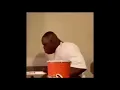 Guy falls out his chair trying to get drink