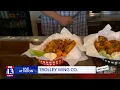 Trolley Wing Co shows Budah their wing selection