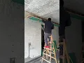 The process of installing drywall on the ceiling