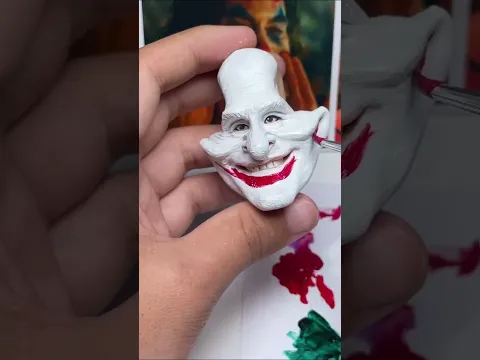 A handmade clay Joker with a creepy smile.