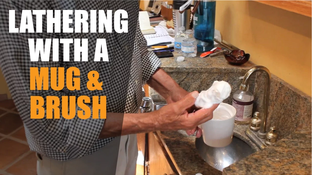 using a traditional shaving mug and brush - creating the lather