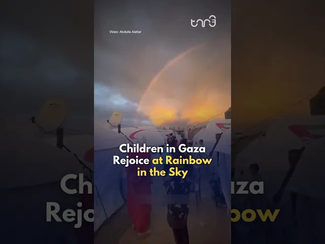 Children in Gaza rejoice at a rainbow in the sky.