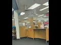 A man walks behind the CVS pharmacy counter grabs prescription medication