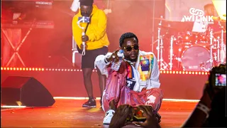 kizz daniel fall down as he pours water and performing pour me water live for his fans