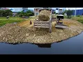 Download Lagu Strong Bulldozer pushing Stone into the Lake