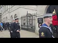 navy officer and kings guard salute each other