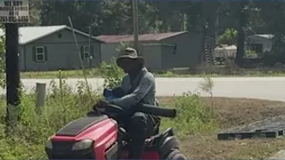 Man clears tall grass near bus stops after seeing children walking along busy road in Houston area