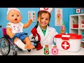 Maya is playing doctor and helping a doll and other toys get better