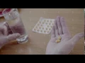 Close-up of round yellow pills in the palm of mature older person