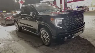GMC DENALI ULTIMATE WITH CHROME WHEELS AT NIGHT