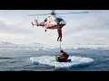 Helicopter rescue training in ocean waves aerial rescue team emergency medical evacuation