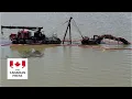 Download Lagu Excavator-turned-landmark stuck in Saskatchewan lake removed 11 years later