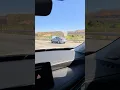 Driver driving in the Cajon Pass with his hood open