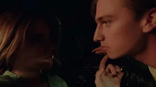 Romantic couple inside a car at night