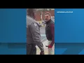 shows a man screaming racist slurs at a security guard outside a Social Security office