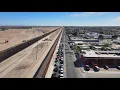Flyover border wall between San Luis AZ and San Luis Rio Colorado Mexico Long line coming into US