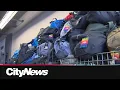 Volunteers pack distribute thousands of winter survival kits for Toronto s unhoused
