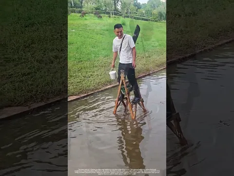 Crossing a water‑filled ditch with an A‑frame wooden ladder