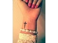 small cross tattoo on wrist